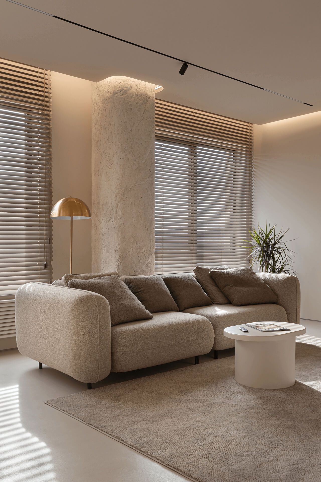 Вітальня з м’яким диваном, кремовим журнальним столиком і торшером у формі гриба